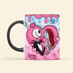 May include: A ceramic mug featuring Jack Skellington and Sally from The Nightmare Before Christmas, set against a pink heart and blue background. The mug has a black handle and rim, with the words "David & Sophia" printed on the side.