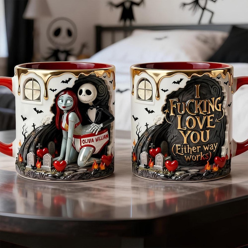 May include: Two ceramic mugs with red handles and rims. One mug features Sally and Jack Skellington, the other has the text "I Fucking Love You". Both mugs have gold accents, black bats, and heart-shaped details.