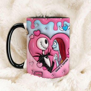 May include: A ceramic mug with a black handle, depicting Jack Skellington and Sally from The Nightmare Before Christmas within a pink heart and blue backdrop. The mug includes the text "David & Sophia" and "To Love".