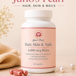 May include: A white plastic bottle of Juno's Pearl Hair, Skin & Nails supplement with a pink label. The label features a lotus icon, 5,000 mcg Biotin, Hydrolyzed Collagen, Hyaluronic Acid, 14 nutrients, and 60 capsules. Three pink capsules sit nearby.