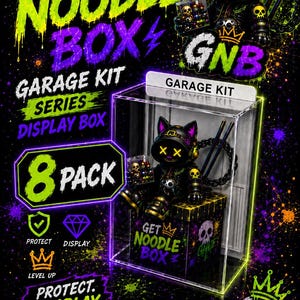 May include: A clear acrylic display box for a garage kit series, featuring a black cat-themed figurine with yellow X-shaped eyes, a crown, and skull motifs. The box is labeled GARAGE KIT and GET NOODLE BOX, with neon green and purple paint splatter accents.