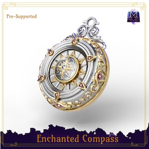 May include: A silver and gold pendant with a compass design. The compass has a starburst pattern in the centre, surrounded by gold accents and red gemstones. The text "Enchanted Compass" is at the bottom.