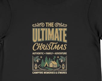 May include: A black short-sleeve t-shirt featuring a graphic print with the text THE ULTIMATE CHRISTMAS, AUTHENTIC FAMILY ADVENTURE, and CAMPFIRE MEMORIES & S'MORES, along with an illustration of a cabin, trees, and lanterns in tan and green.