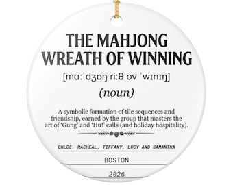 May include: A round white ceramic ornament featuring black text that reads THE MAHJONG WREATH OF WINNING, phonetic spelling, noun definition, names CHLOE, RACHEAL, TIFFANY, LUCY AND SAMANTHA, BOSTON, and 2026. It includes a gold hanging string at the top.