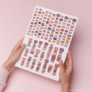 A paper sheet held by hands, with cut-out letters, numbers, and symbols in various colours. Words such as "love", "coffee", and "home" are visible. The background is a soft pink.