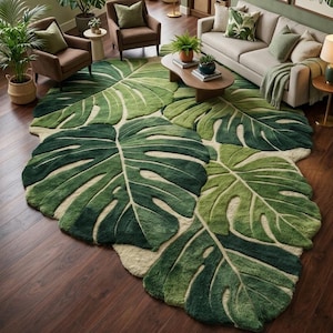May include: A large, green rug shaped like monstera leaves dominates a living room. The rug's design features varying shades of green, creating a textured, three-dimensional effect. The room is decorated with plants, brown furniture, and framed botanical prints.