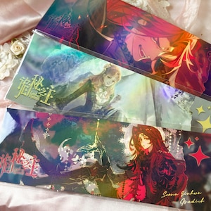 May include: Three rectangular bookmarks featuring Lord of the Mysteries anime-style illustrations. The top shows a red-haired character, the middle a woman in a dark dress, and the bottom a red-haired figure with stars and text in a glossy finish.
