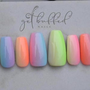 May include: A collection of ten false nails, each with a unique gradient design. The colours include blue, pink, orange, and green hues. The cursive text "get buffed NAILS" is visible at the top of the image.