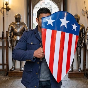 May include: A kite-shaped shield featuring a blue upper section with three white five-pointed stars and a lower section with vertical red and white stripes. The shield has a smooth, glossy finish and a pointed bottom edge, held by a handle on the back.