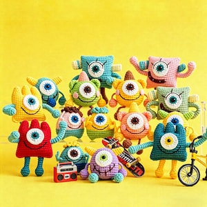May include: A collection of colorful, crocheted monster toys with one large eye, arms, and legs. The monsters are in various colors, including red, yellow, blue, green, and pink. Some monsters have accessories like a skateboard, a boombox, and a bicycle.