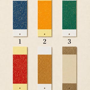 May include: Six rectangular paper swatches arranged in two rows, numbered one through six. Each swatch features a central coloured section with a speckled texture, flanked by solid-coloured top and bottom borders, and a small hole at the bottom.