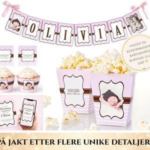 Puede incluir: Decoraciones de fiesta rosas y marrones con el nombre "Olivia" en una pancarta, cajas de palomitas de ma&iacute;z, cupcakes e invitaciones. Las decoraciones incluyen una foto de beb&eacute; y la palabra "Enjoy!" en los adornos de cupcakes.