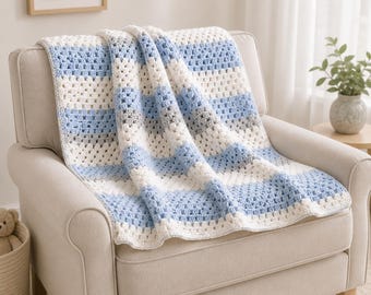 May include: A handmade crochet blanket featuring a repeating granny square stitch pattern. The textile displays horizontal stripes in alternating colors of soft baby blue, crisp white, and light grey, creating a textured and layered appearance.
