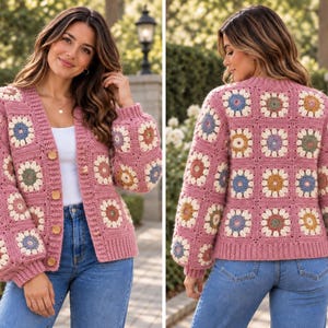 May include: A long-sleeve crochet cardigan featuring a pink base with a repeating granny square pattern. Each square contains a multi-colored floral motif in shades of blue, yellow, and green. The cardigan has a V-neckline and four wooden buttons.