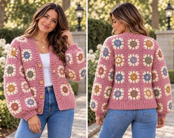 May include: A long-sleeve crochet cardigan featuring a pink base with a repeating granny square pattern. Each square contains a multi-colored floral motif in shades of blue, yellow, and green. The cardigan has a V-neckline and four wooden buttons.