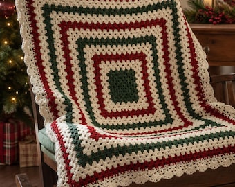 May include: A square crochet blanket featuring a concentric granny square pattern in alternating bands of dark green, cream, and deep red. The blanket is finished with a decorative scalloped cream-colored border along all four edges.