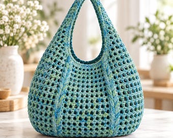 May include: A hand-crocheted hobo bag featuring an open-weave grid pattern in variegated shades of teal, turquoise, and lime green. The bag has a single integrated handle and vertical braided detailing along the front, creating a structured shape.
