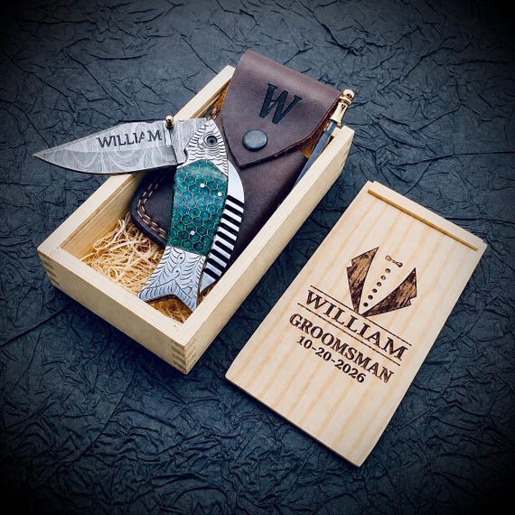 A custom engraved handmade folding knife packaged with a leather pouch and gift box — the full presentation set makes this feel like a genuine heirloom piece.