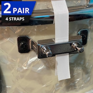 May include: Close-up of a drum with a white strap and metal hardware. The text "2 PAIR 4 STRAPS" is in a blue and black banner in the upper left corner. The drum has a pearlescent finish.