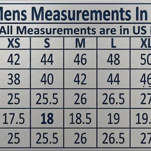 May include: A rectangular sizing chart titled Mens Measurements In Inches with the subtitle All Measurements are in US Letters. The table lists sizes from XXS to 4XL with corresponding numerical values in inches for chest, waist, sleeves, shoulders, and length.