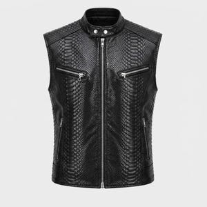 May include: A black sleeveless vest featuring a textured snakeskin pattern throughout. The garment includes a stand-up collar with two silver-tone snap buttons, a full-length center zipper, two zippered chest pockets, and two lower zippered pockets.