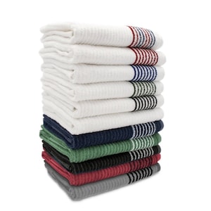 May include: A pile of white, textured towels with striped borders in shades of red, blue, green, and black. The towels are neatly folded and stacked, giving a clean and organised look. The towels are made of a soft material.