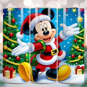 May include: A tumbler featuring Mickey Mouse in a Santa Claus outfit, set against a snowy blue backdrop with Christmas trees, ornaments, and gifts. The design includes a yellow star and falling snowflakes.