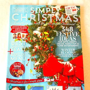 May include: A magazine cover titled "Simply Christmas" with a festive wreath and a large red bow. The cover features text about recipes, gift ideas, and home entertaining. The magazine includes images of a decorated Christmas tree and Santa Claus.