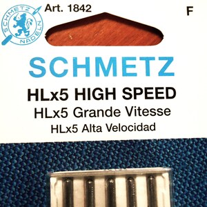 Op de afbeelding: Een verpakking SCHMETZ HLx5 HIGH SPEED naaimachinenaalden. De verpakking heeft het SCHMETZ-logo en de tekst "Art. 1842". De tekst "HLx5 Grande Vitesse" en "HLx5 Alta Velocidad" zijn ook zichtbaar.
