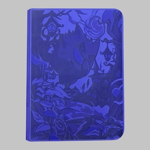 May include: A rectangular purple binder featuring a monochromatic embossed illustration of a Gengar character surrounded by a spooky forest, twisted trees, hanging lanterns, and a full moon. The cover has a textured finish and rounded corners.