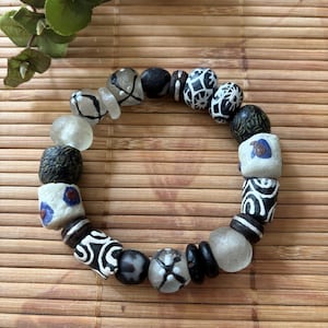 African trade bead bracelet with hand painted black and clear Krobo beads from Ghana, and two antique white trade beads - unisex