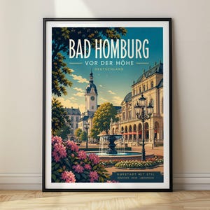 May include: A framed travel poster of Bad Homburg vor der Höhe, Germany, featuring a central fountain, a historic building with a clock tower, and pink flowers in the foreground. The text reads BAD HOMBURG VOR DER HÖHE DEUTSCHLAND KURSTADT MIT STIL.