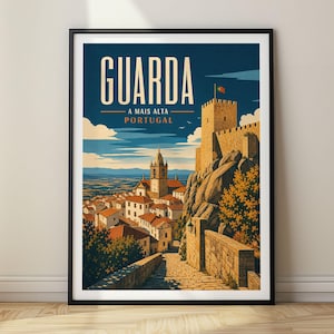 May include: A framed travel poster featuring a stone castle on a rocky hill overlooking a town with red-roofed buildings. The text reads GUARDA A MAIS ALTA PORTUGAL. The sky is deep blue with clouds, and a small Portuguese flag flies atop the tower.