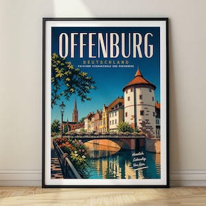 May include: A framed travel poster of Offenburg, Deutschland, featuring a historic town scene with a stone tower, a bridge over a canal, and colorful flowers. The text reads OFFENBURG DEUTSCHLAND ZWISCHEN SCHWARZWALD UND RHEINEBENE and Herzlich. Lebendig. Von hier.