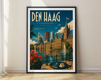 May include: A framed travel poster of Den Haag, Netherlands, featuring a city skyline with historic and modern buildings, a fountain, and a waterfront terrace with a table, chair, a book titled Vrede in Recht, and a cup of coffee near red flowers.