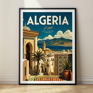 May include: A framed travel poster featuring the word ALGERIA in large white letters, with Arabic text and the phrase LAND OF HERITAGE & HORIZONS below. The illustration depicts a coastal city with white buildings, a palm tree, and mountains.
