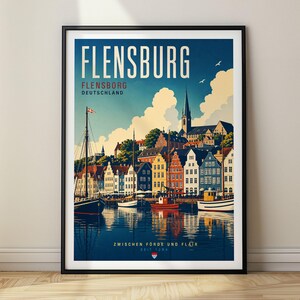 May include: A framed travel poster of Flensburg, Germany, featuring a harbor with colorful buildings, sailboats, and a church spire under a blue sky. The text reads FLENSBURG, FLENSBORG DEUTSCHLAND, and ZWISCHEN FÖRDE UND FLAIR SEIT 1284.
