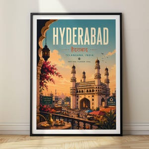 May include: A framed travel poster of Hyderabad, India, featuring the Charminar monument under a sunset sky. The illustration includes an arched balcony with a lantern, a table with tea, and text reading HYDERABAD, TELANGANA, INDIA, HERITAGE, FLAVOUR, SOUL.