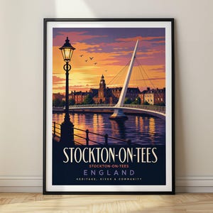 May include: A framed travel poster featuring a sunset view of the Infinity Bridge in Stockton-on-Tees, England. The illustration includes a tall street lamp, the river, and city buildings. The text reads STOCKTON-ON-TEES, ENGLAND, HERITAGE, RIVER & COMMUNITY.