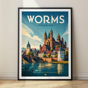 May include: A framed travel poster featuring a stylised illustration of the Worms Cathedral in Germany. The artwork displays the city skyline, a stone bridge, and a river in shades of blue, cream, and brown. The text reads WORMS DEUTSCHLAND.