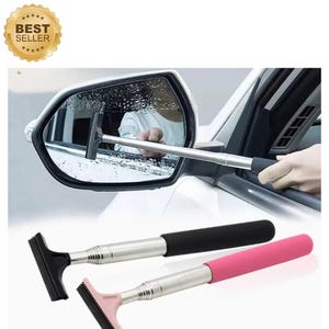 May include: A car side mirror being cleaned with a black squeegee. Below, two extendable squeegees with black and pink handles are displayed. The squeegees have black rubber blades and silver telescopic poles. A gold "Best Seller" sticker is in the upper left corner.