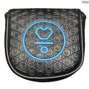 May include: Black golf club head cover with a blue embroidered emblem. The cover has a textured pattern of circles and hearts. The emblem is a blue crown inside a circle with the letters "OK" and a small circle below.