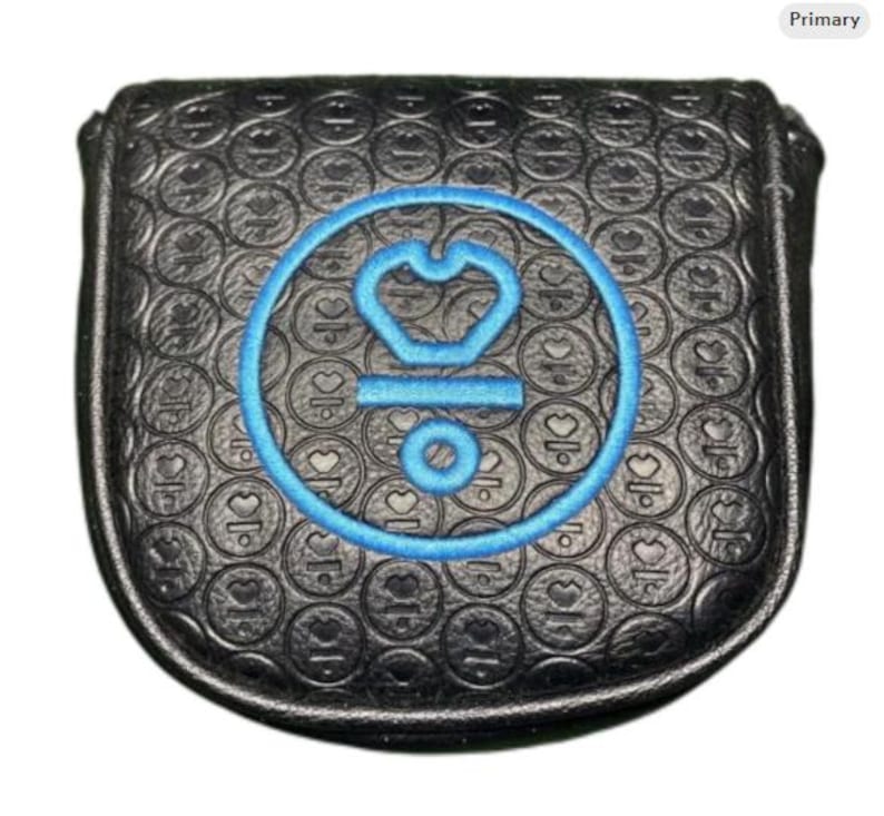 May include: Black golf club head cover with a blue embroidered emblem. The cover has a textured pattern of circles and hearts. The emblem is a blue crown inside a circle with the letters "OK" and a small circle below.
