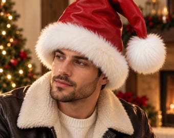 May include: A red faux leather Santa hat featuring a thick, white faux fur trim around the base and a large, fluffy white pom-pom attached to the pointed tip. The hat has a smooth, slightly glossy texture and a structured, conical shape.