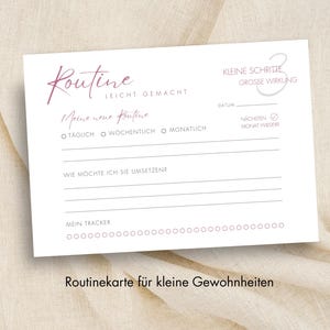 May include: A white card with the word "Routine" in a cursive font, along with other text and checkboxes. The card also includes the phrase "Meine neue Routine" and the text "Routinekarte für kleine Gewohnheiten".
