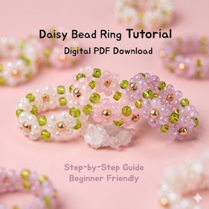 May include: Several daisy bead rings in various colors, including white, pink, and purple, are displayed on a pink background. The rings feature gold-colored beads and green accents. Text on the image reads "Daisy Bead Ring Tutorial" and "Digital PDF Download."