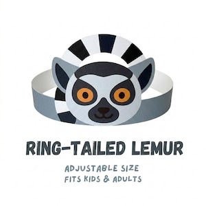 May include: A paper ring-tailed lemur headband with a gray and white design. The lemur's face is centered, featuring orange eyes and a black nose. The text "RING-TAILED LEMUR" and "ADJUSTABLE SIZE FITS KIDS & ADULTS" are below the headband.