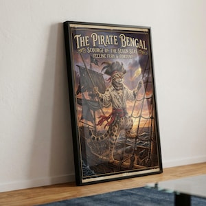 May include: A framed vertical poster titled The Pirate Bengal Scourge of the Seven Seas Feeline Fury & Fortune. The artwork depicts a Bengal cat dressed as a pirate captain standing on the deck of a ship at sunset with rigging and sails visible.
