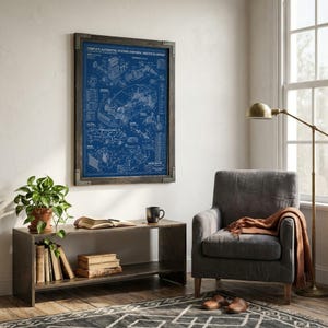 May include: A framed wall art print featuring a blue and white technical blueprint titled Complete Automotive Systems Overview Master Blueprint, displaying detailed mechanical diagrams of a car engine and chassis components in a dark wood frame.