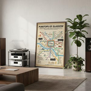 May include: A framed wall poster titled Pubstops of Glasgow featuring a colourful transit-style map of the city's pubs, bars, and breweries with lines connecting various districts and landmarks on a light cream background with dark brown frame.